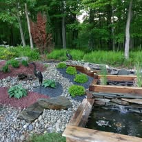 Custom water feature with stone surround and plantings