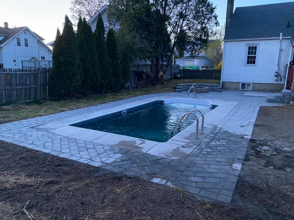 Rebuilt pool patio with paver surround and seating area